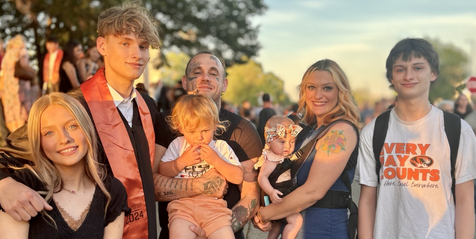Simoriah with her husband and five children at a family graduation
